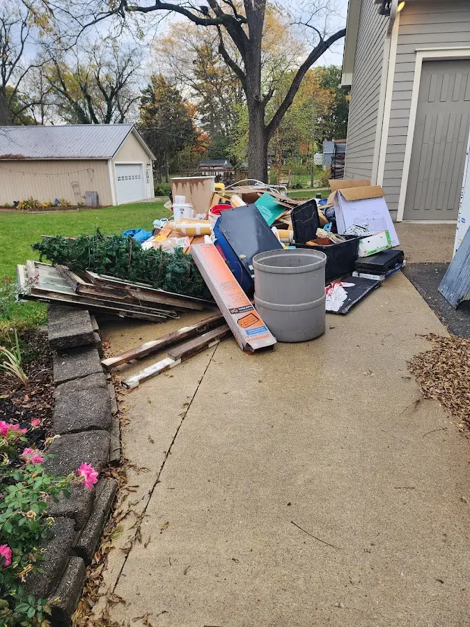 Dumpster being loaded with debris for Roofing Dumpster Rental in Lyons